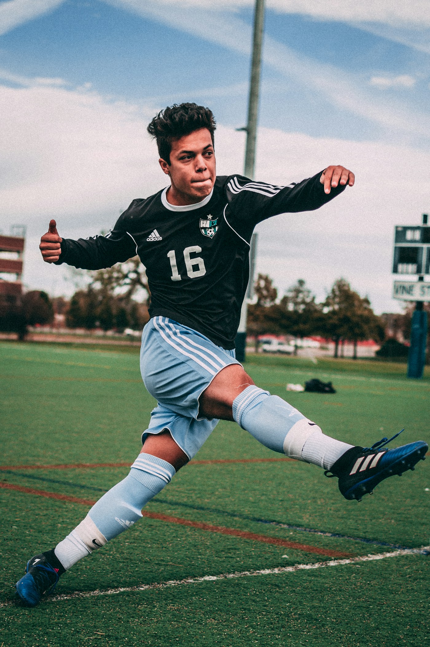 A determined footballer striking the ball during training